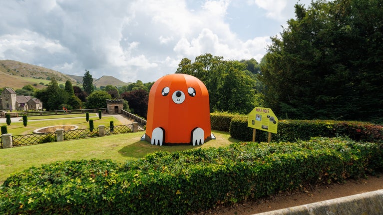 View of Italian Gardens with a giant brightly coloured sculpture of a mole in the foreground.